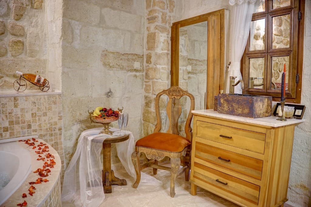 Stone bathroom with jacuzzi and private bath area